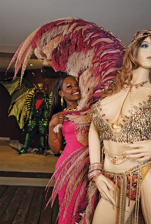 A visitor tries on a Carnival costume at the museum. The museum's creator, Gerald Hart, made his reputation as one of the islands' most prolific Carnival costume designers.