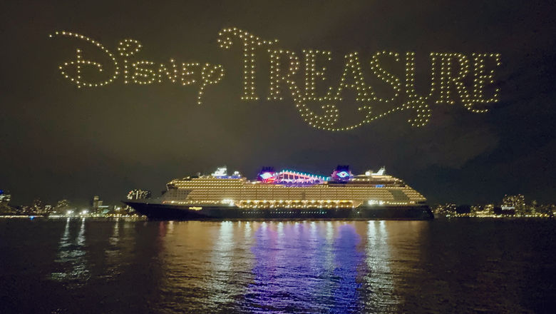 Drones form the name of the ship above the Disney Treasure.