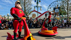 Mr. and Mrs. Incredible in hovercraft during the Better Together: A Pixar Pals Celebration parade.