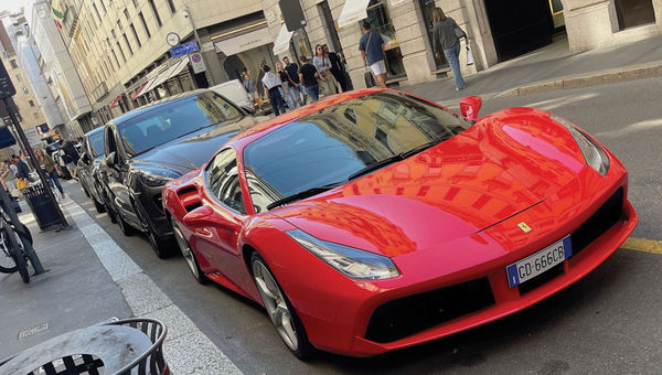 High-end sports cars on Via Montenapoleone in Milan's Golden Quad, home to the flagship stores of world-renowned designers.