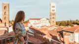 A solo guest takes in a terrace view at the Grand Universe Lucca in Tuscany. In response to a large percentage of solo travelers in Italy, it launched an offer called Solo & Spritzing.