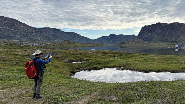 Lindblad's director of expedition photography, Rich Reid, shooting a landscape in western Greenland in July. The company will begin implementing the new branding on National Geographic-Lindblad Expeditions ships next year.